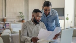 CF Money Article | couple reading through paperwork